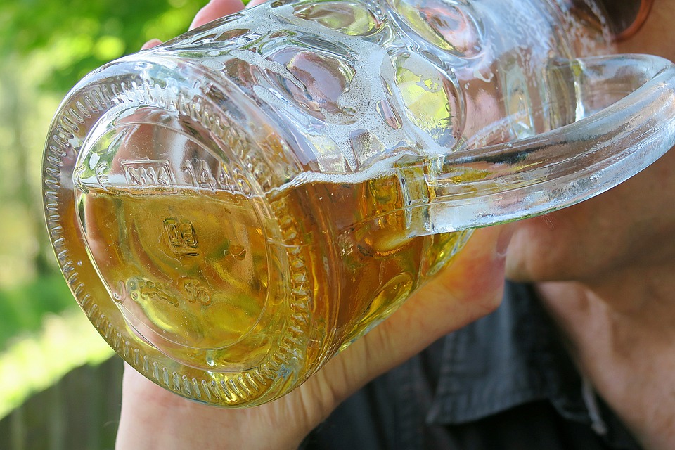 Photo of a Munich beer garden patron drinking a pint glass of beer