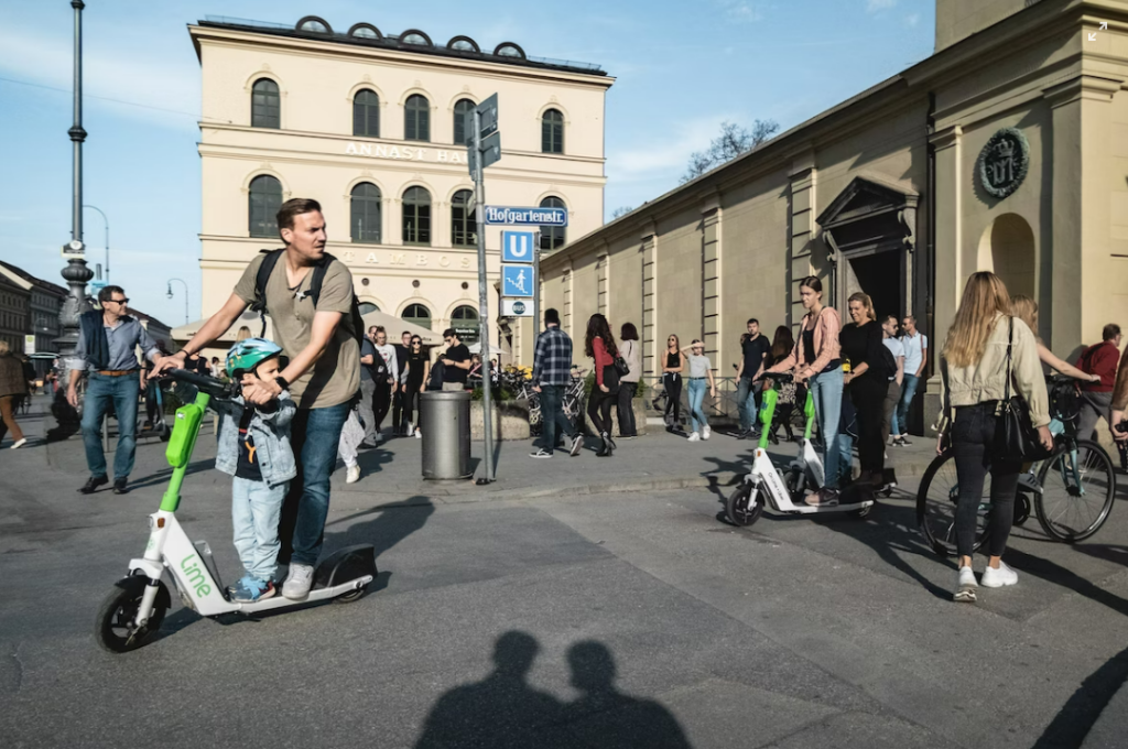 photo of tourists and locals using e-scooters and bicycles in central Munich