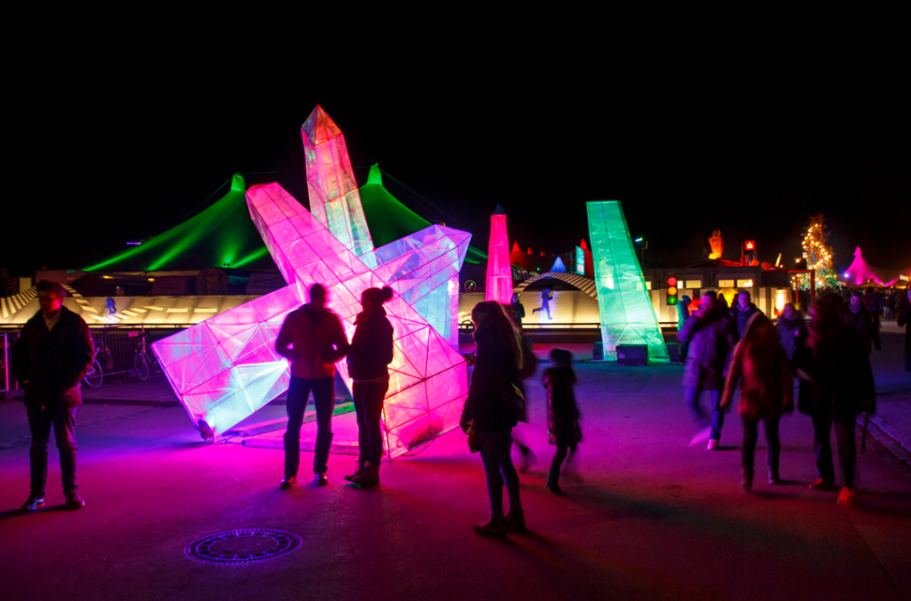 photo of people enjoying the light shows at Tollwood Winter Festival in Munich Germany