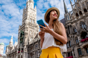 photo of a young tourist in front of the famous town hall building during summertime in Munich